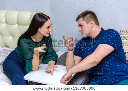 Family relations, problems, family conflict between husband and wife. They sit in the room right in front of the camera and look unhappy