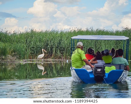 Tourists on a boat in the Danube Delta, Romania
 Royalty-Free Stock Photo #1189394425