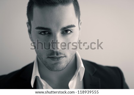 Confident young man close up portrait. Sepia tone image.