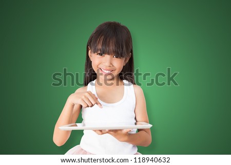 Asian girl using tablet PC over green background with clipping path