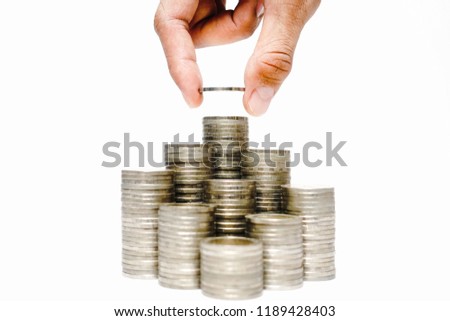 Business growth concept, Financial growth ,Man's hand put money coins on coins stack,Increasing piles of coins,Budget Planning