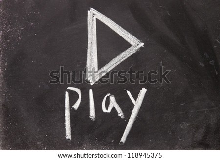 play sign drawn with chalk on blackboard Royalty-Free Stock Photo #118945375