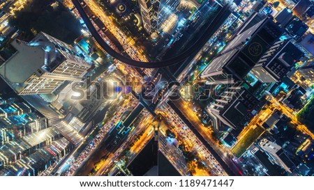 Aerial view highway road intersection at night for transportation, distribution or traffic background.