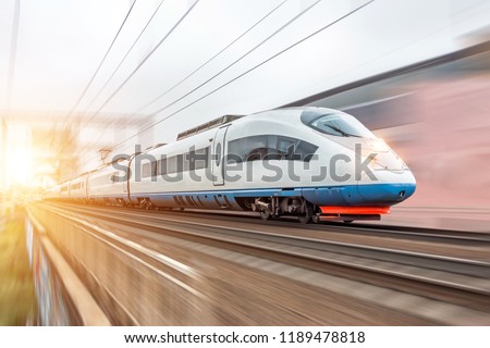 High speed fast train passenger locomotive in motion at the railway station city Royalty-Free Stock Photo #1189478818