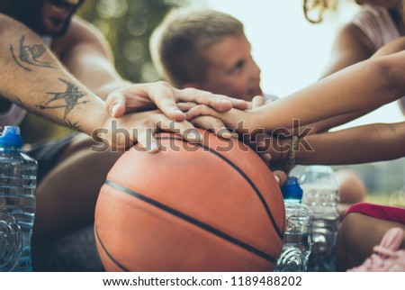 We are the best team ever. Focus is on hands on a basketball ball. 