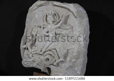 Ancient stone with a picture on a black background. Rare find of archaeologists