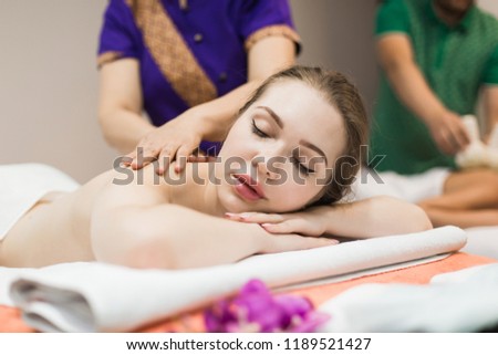 beautiful girl enjoys back massage in spa salon. Procedures for beauty and rejuvenation. Thai massage