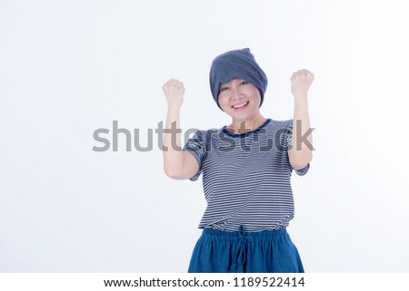 Happy beautiful cancer woman looking at the camera and show her hand fighting with her illness on isolated background 
