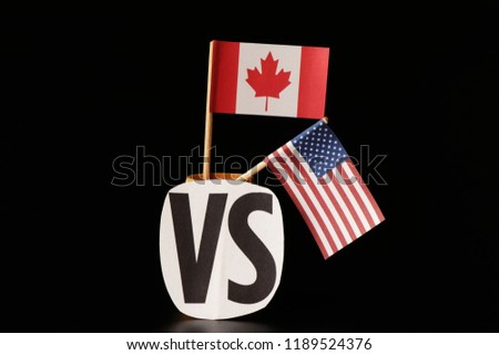 A national flag of Canada and flag of united states. Both lands have different opinions but same language. Black background