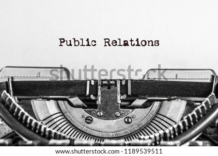 Public Relations text typed on a Vintage Typewriter. black ink on old paper.