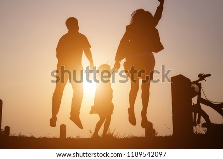 Happy family: mother father and child daughter on nature on sunset