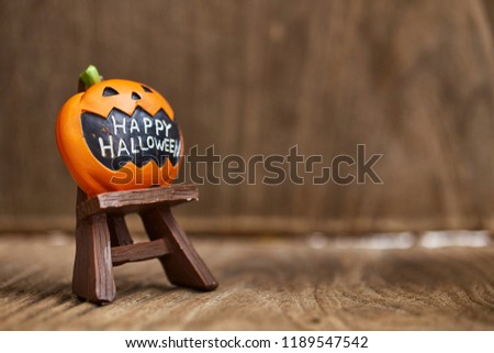 Creative Composition for Halloween Pumpkin Toy Decoration on wooden table background Holiday Ideas for Halloween Party Decoration with Trick or Treat, Moonlight in the room