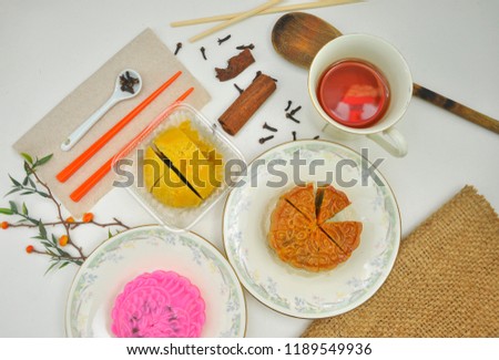Mid autumn festival moon cake and hot tea isolated on white background with sack. Chinese mid autumn festival food concept.