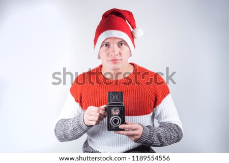 Santa Claus taking picture with old camera. 