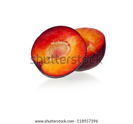 Halves of red plum fruit isolated on white background