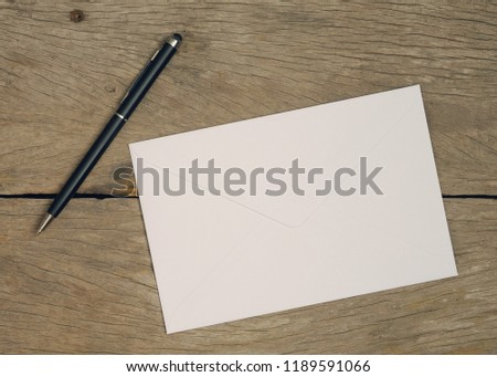 Blank envelope on wooden background. Top view.With copy space.