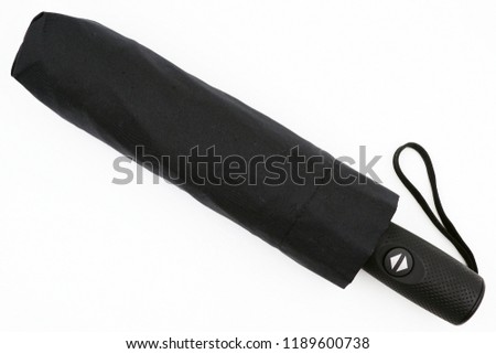 Black umbrella with automatic open and close button
 Royalty-Free Stock Photo #1189600738