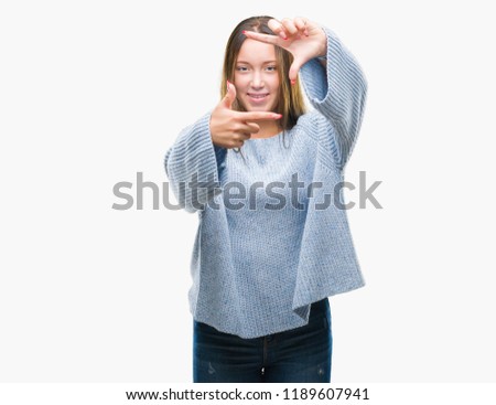 Young beautiful caucasian woman wearing winter sweater over isolated background smiling making frame with hands and fingers with happy face. Creativity and photography concept.