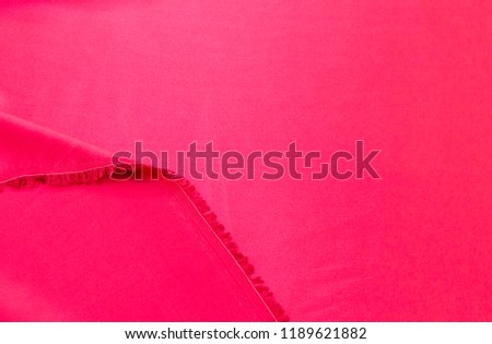 Abstract background texture of natural red color fabric. Fabric texture of natural cotton or linen, silk or satin, wool or jersey textile material. Luxurious red canvas background.
 Royalty-Free Stock Photo #1189621882
