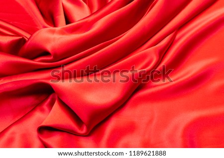 Abstract background texture of natural red color fabric. Fabric texture of natural cotton or linen, silk or satin, wool or jersey textile material. Luxurious red canvas background.
 Royalty-Free Stock Photo #1189621888