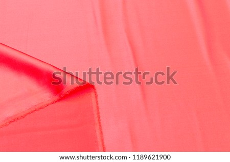Abstract background texture of natural red color fabric. Fabric texture of natural cotton or linen, silk or satin, wool or jersey textile material. Luxurious red canvas background.
 Royalty-Free Stock Photo #1189621900