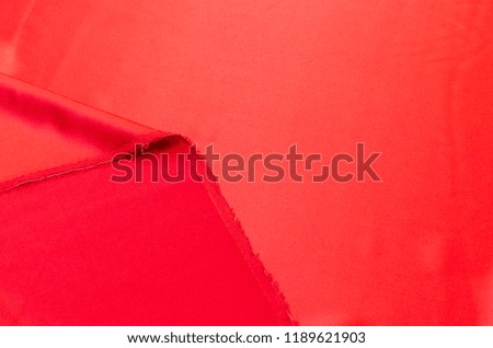 Abstract background texture of natural red color fabric. Fabric texture of natural cotton or linen, silk or satin, wool or jersey textile material. Luxurious red canvas background.
 Royalty-Free Stock Photo #1189621903