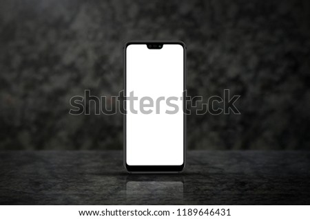 New version of smart phone with touchscreen isolated on dark marble background