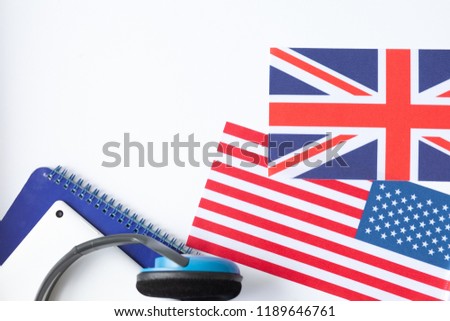 Learn English - British flag, headphones, tablet and notebook on a white background