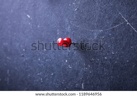 Pushpin in the blackboard closeup
