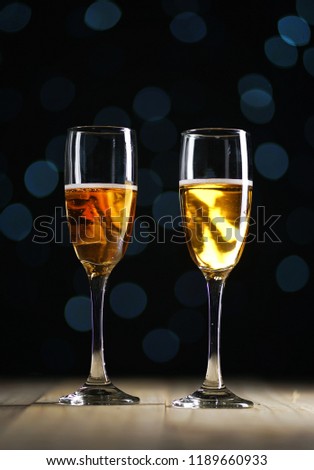 Two Glasses of Champagne Dark Glow Lights Background