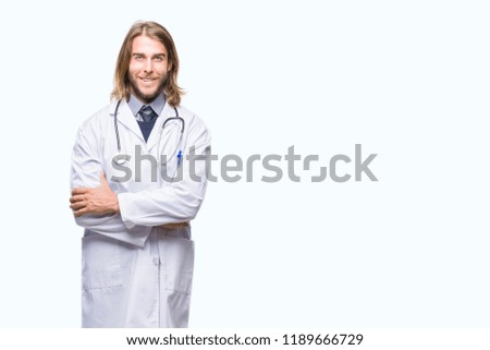Young handsome doctor man with long hair over isolated background happy face smiling with crossed arms looking at the camera. Positive person.