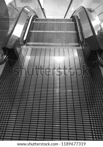 Escalator in Community Mall, Shopping Center in Thai. Moving up staircase. electric escalator. Close up to escalators. Close up floor platform. 