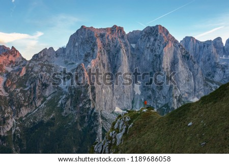 Tourist, climber on a high rocks staring at the Prokletije mountine stunning cliffs. Sport, active life and travel concept. Prokletije National Park, Montenegro Royalty-Free Stock Photo #1189686058