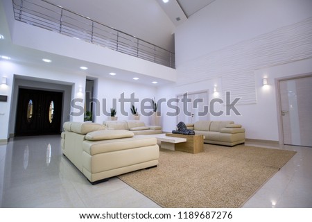 interior of the entrance hall of a  house with leather sofas
