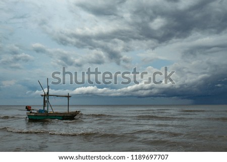 Fishing boats and The rain that is falling in the sea.