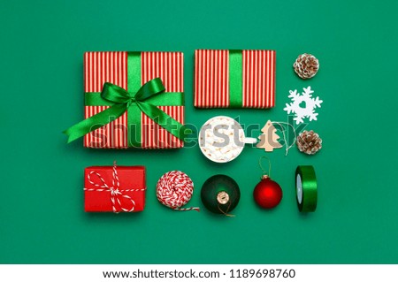 
Gift boxes, Christmas balls, toys, fir cones, ribbon on green background. Festive, congratulation, New Year Christmas presents Xmas holiday 2019 greeting card. Flat lay, top view, copy space.