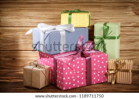 Many gifts box with ribbon on wooden background top view. New year and Christmas holiday concept. Flat lay with copy space. Discount gift for sale day.