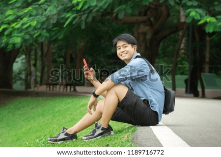 Asian Man Sitting Listening Music