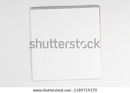 notebook with a blank sheet on a white background top view. Flat lay with copy space.