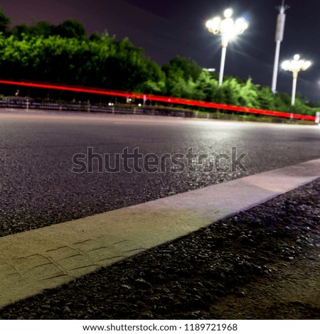 Empty asphalt road and modern skyline at night