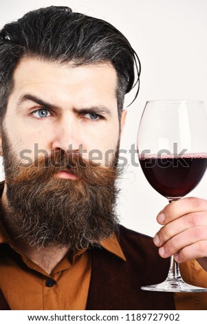 Waiter with tray and glass of red wine. Man with beard holds alcohol on white background, close up. Barman with serious face holds italian alcoholic drink. Service and restaurant catering concept.