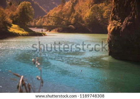 fisherman in a mountain lake, autumn landscape