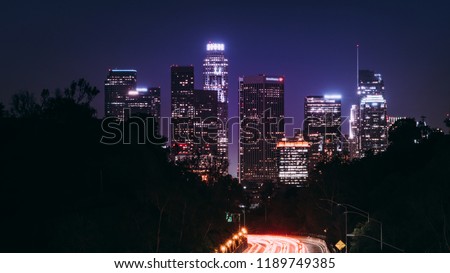 Downtown Los Angeles at night view from highway leading to city
