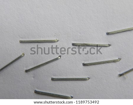 Many front side staples on white paper Royalty-Free Stock Photo #1189753492