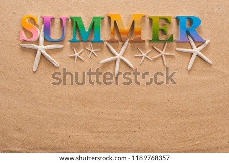 summer written in colorful letters decorate with starfish on the beach with copy space