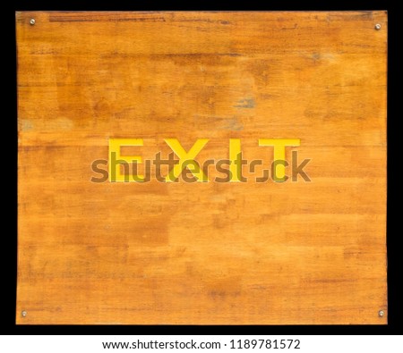 Exit sign on old and dirty wood board. isolated on black background.