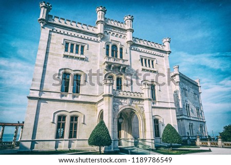 Miramare castle near Trieste, northeastern Italy. Travel destination. Beautiful architecture. Analog photo filter with scratches.