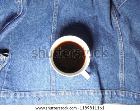 Coffee and coffee bean In the cup coffee On Jeans