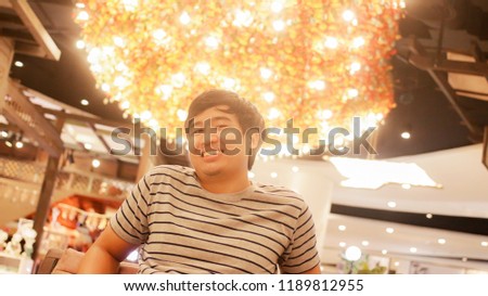 Man love shopping, walking, shooting in the new mall Beautiful light background in Phuket Thailand.