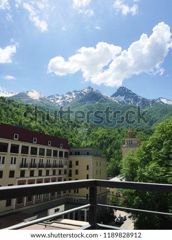 Beautiful mountain view from balcony. Rosa Khutor, Sochi, Russia.  Amazing picture of green mountain landscape with blue sky and white clouds. 